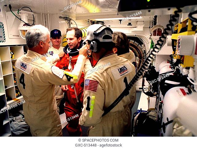 05/27/1999 --- Before entering the orbiter Discovery, STS-96 Mission Specialist Valery Ivanovich Tokarev center is checked out by white room closeout crew...