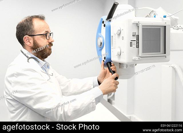 Doctor operating X-ray machine in radiology department. High quality photography