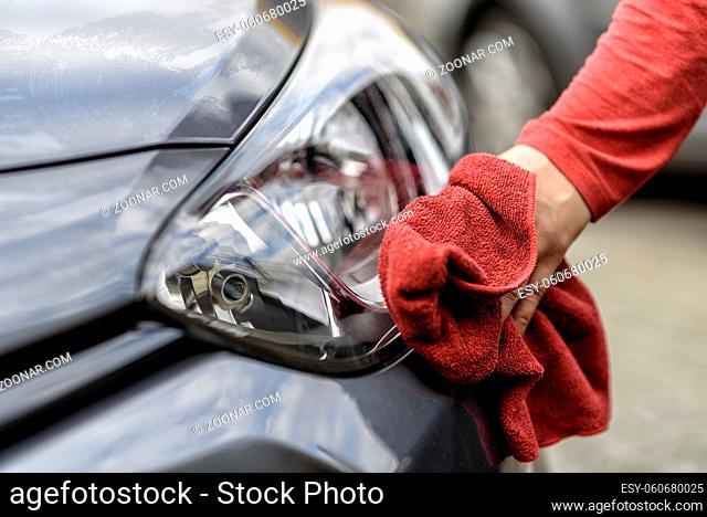 polishing a car with a rag after the car wash