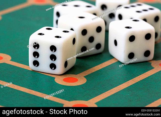 Several white dices on board game background