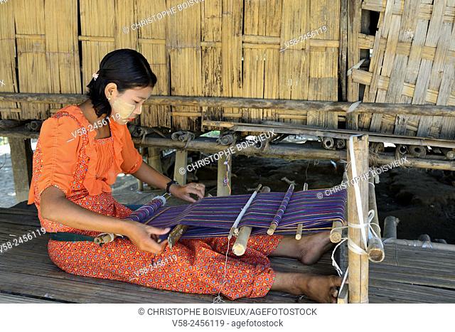 Myanmar, Rakhine State, Mrauk U region, Pan Ba village, Young Chin girl weaving a cotton scarf