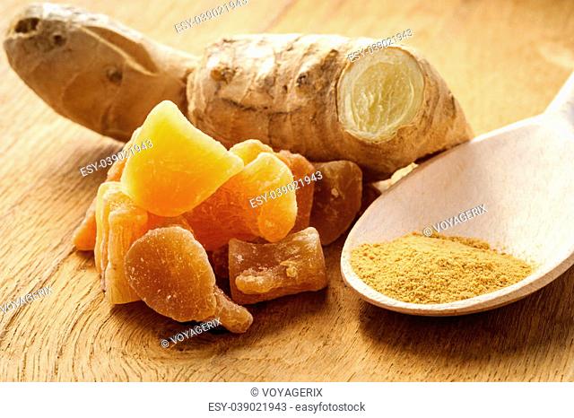 Three kinds of ginger - ground spice fresh and candied on rustic table. Healthy eating, home remedy for nausea upset stomach colds