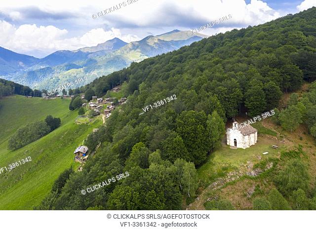 Aerial view of the pastures of Alpone di Curiglia and the church of Madonna della Guardia. Curiglia con Monteviasco, Veddasca valley, Varese district, Lombardy