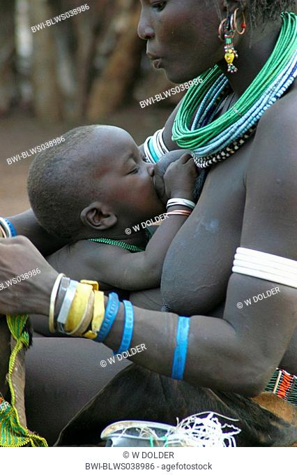 Toposa child suckling at mothers breast , Sudan