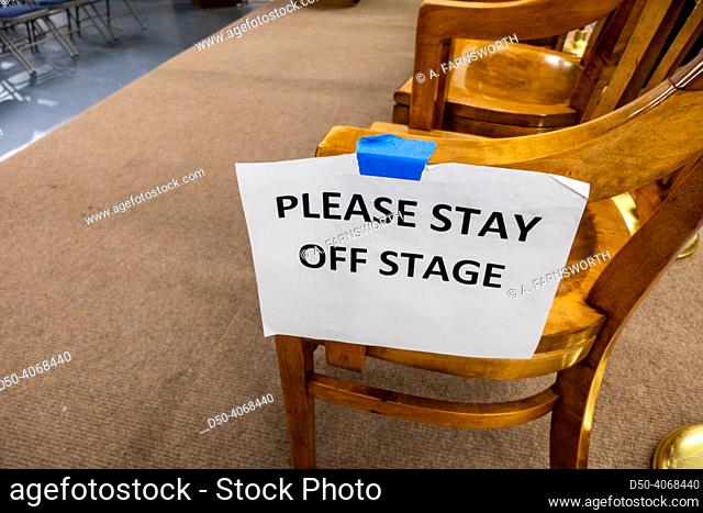 Solomons Maryland, USA A sign on a chair on a public speaking dais says ""Please stay off the stage""