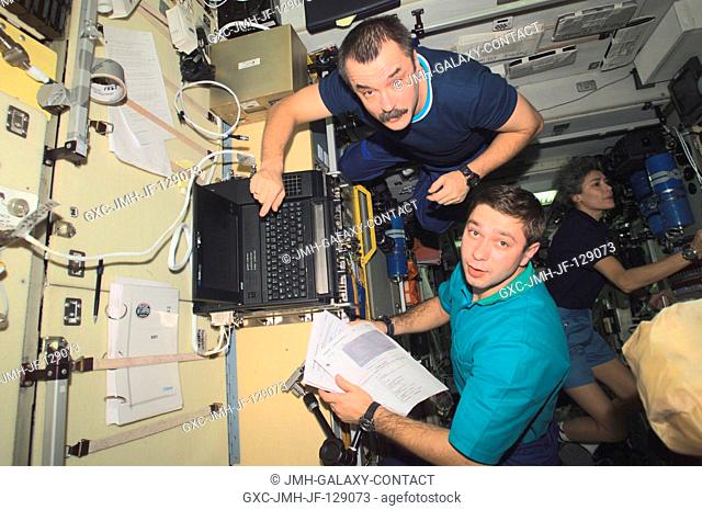 Cosmonaut Mikhail Tyurin (top), Expedition Three flight engineer, and Soyuz Taxi crewmembers, Flight Engineer Konstantin Kozeev and French Flight Engineer...