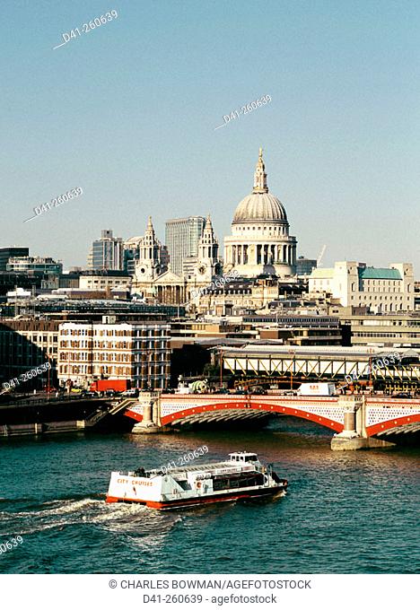 Elevated view of St Paul's Cathedral, Blackfriar's Bridge and tour boat. London. England