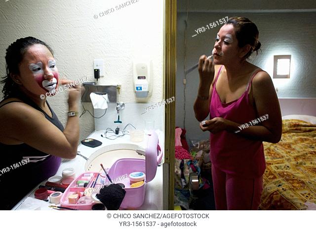 Female clowns put on make-up in front of a mirror in their shared room during the 16th International Clown Convention: The Laughter Fair organized by the Latino...