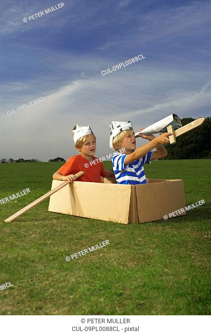 boys in box pretending to be boat