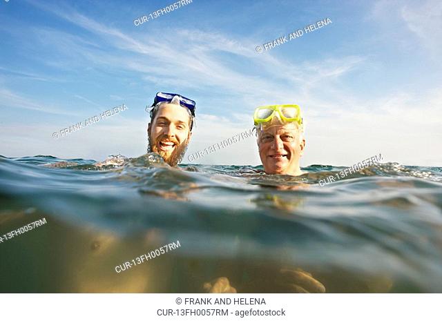 Portrait of two men swimming in sea