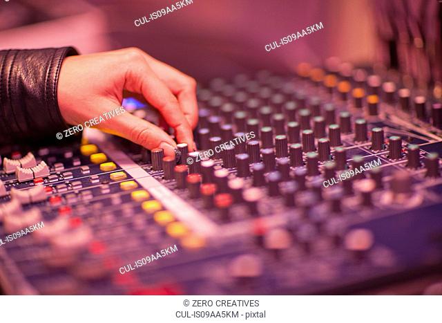 Close up of hand and mixing desk in recording studio