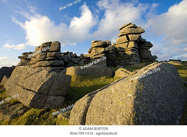 Late afternoon sunlight glows on the granite rock formations of Great Staple Tor in Dartmoor National Park, Devon, England, United Kingdom, Europe