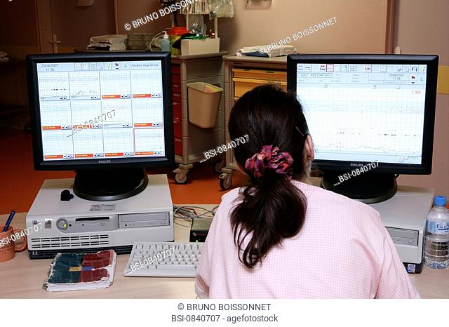 FETAL MONITORING Photo essay at the hospital of Meaux 77, France. Maternity department, labor ward. A midwife is checking a fetal monitoring fetal heart rhythm...