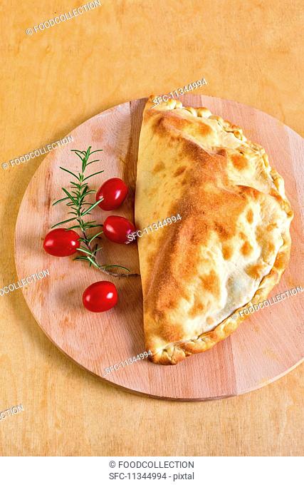 Calzone caprese (a pizza pocket filled with tomatoes and mozzarella, Italy)