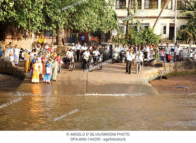 Passengers waiting for the ferry boat at Ribandar jetty to cross the creek to reach Chorao island ; Goa ; India NO MR