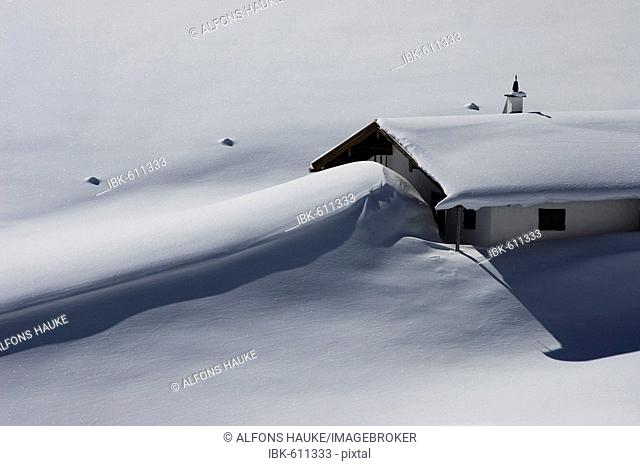 Soinalm (Alpine pasture) covered in snowdrift, Spitzingseeberge range, Bavaria, Germany, Europe