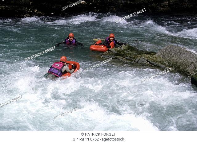 RESCUE WORKERS ON RIVER BOARDS ON THE RAPIDS OF THE DRANSE, HAUTE-SAVOIE 74, FRANCE