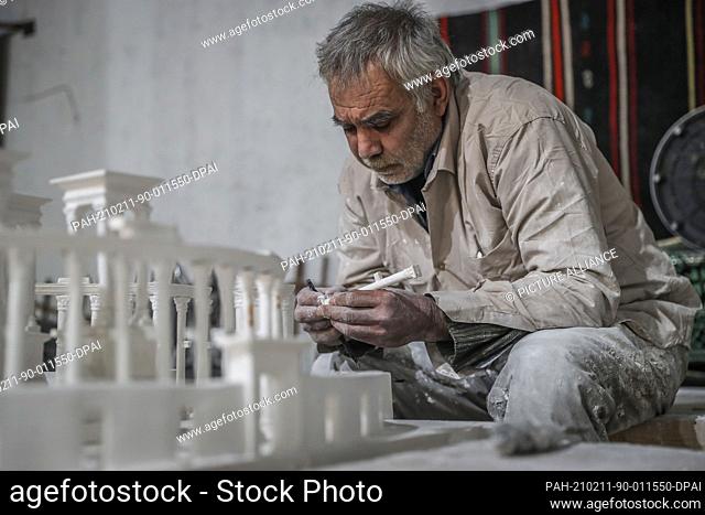 09 February 2021, Syria, Al Bab: A picture made available on 11 February 2021 shows Ali Alsaleh, 58, working at his workshop