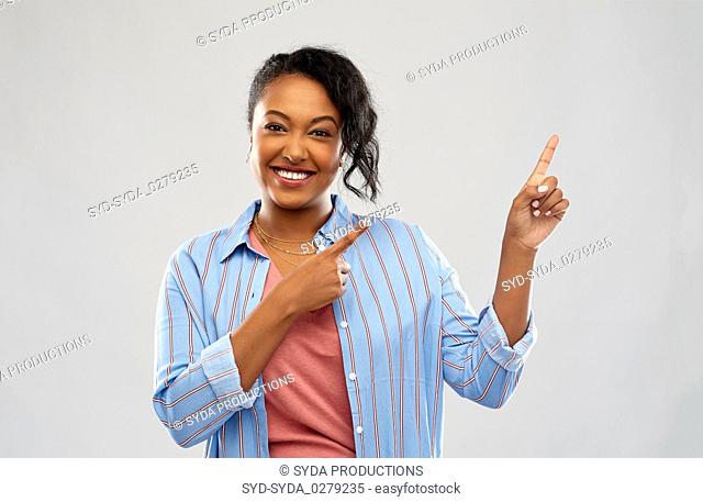 happy african american woman pointing finger up
