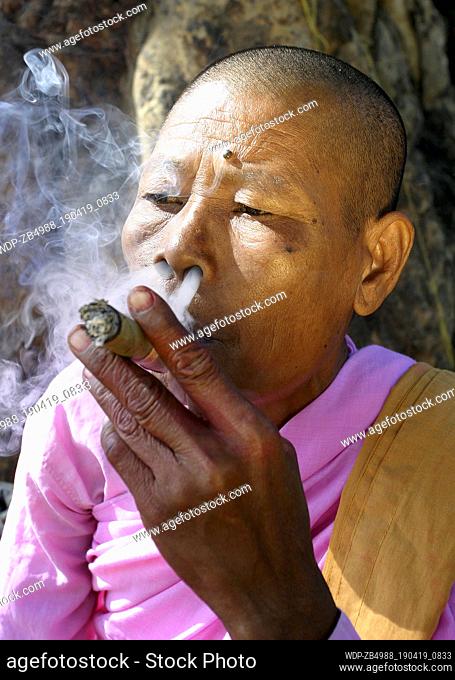 BUDDHIST NUN SMOKING CHEROOT