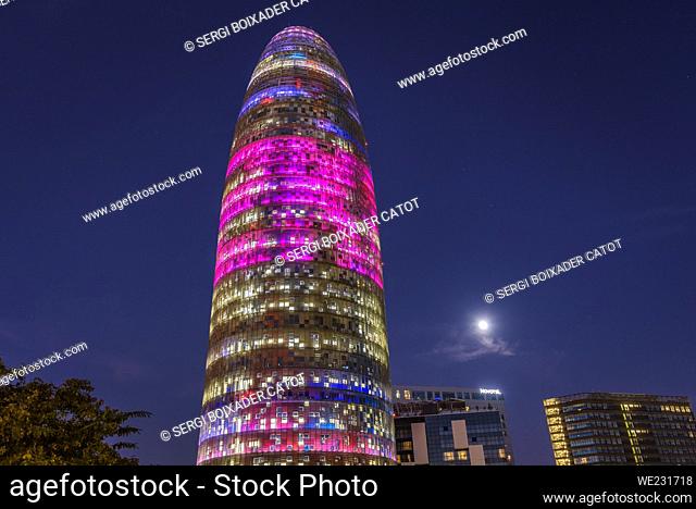 Torre Glòries (formerly Agbar) illuminated at night during the Llum BCN 2023 festival and the Full Moon (Barcelona, Catalonia, Spain)