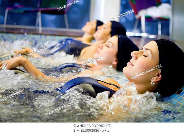 Hispanic woman soaking in hot tub