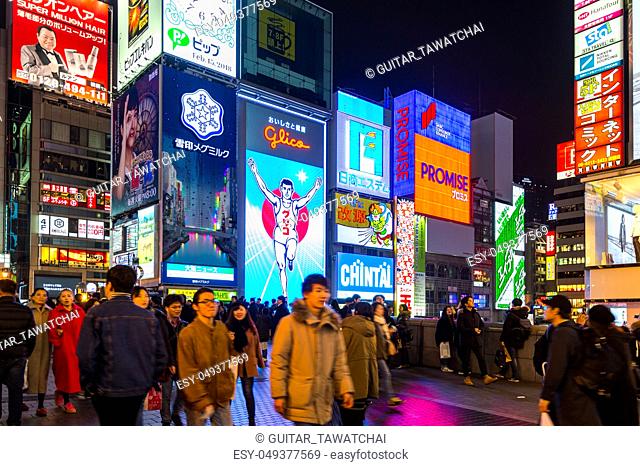 OSAKA, JAPAN - FEB 15, 2018 : Tourist walking in night shopping street at Dotonbori in Osaka, Japan on February 15, 2018