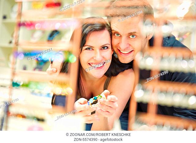 Lachendes Paar beim Shopping nach Schmuck beim Juwelier