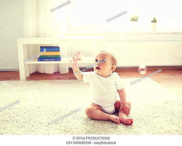 happy baby with soap bubbles at home