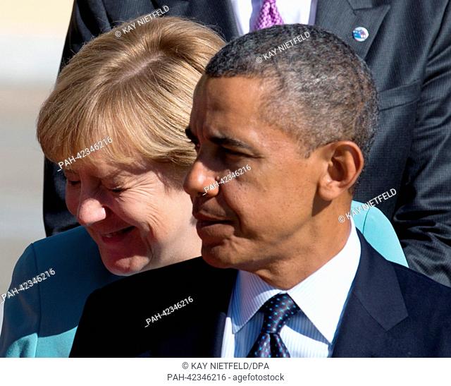 German Chancellor Angela Merkel and US President Barack Obama take their places to pose for the family photo at the G20 summit in St