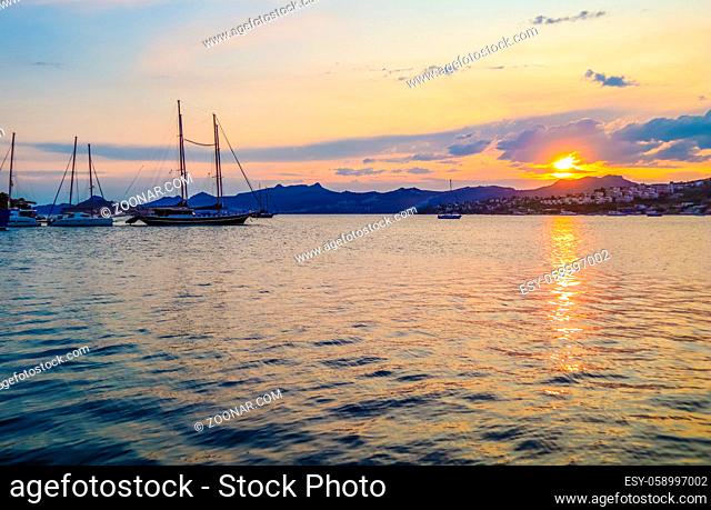 Beautiful Mediterranean coast with islands, mountains and yachts at sunset