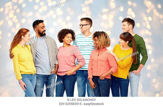 diversity, race, ethnicity and people concept - international group of happy smiling men and women over holidays lights background
