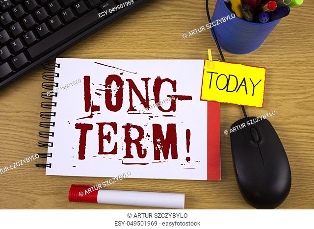Word writing text Long-Term Motivational Call. Business concept for Occurring over large period of time Future plans written Notepad wooden background Today...