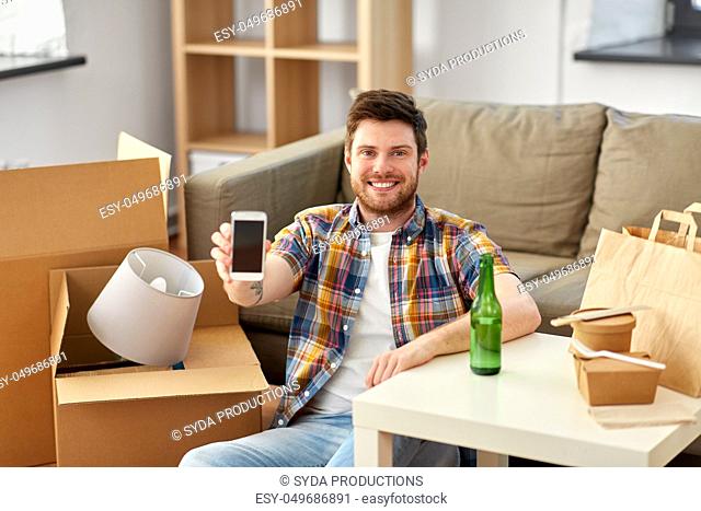 man with smartphone and takeaway food moving