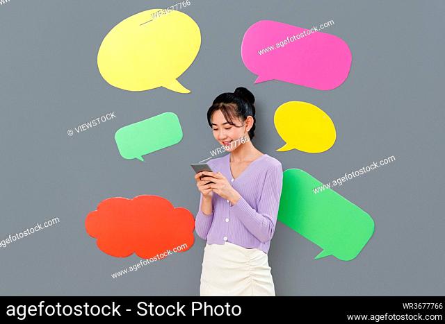 Holding a mobile phone young girl standing in front of the dialog box