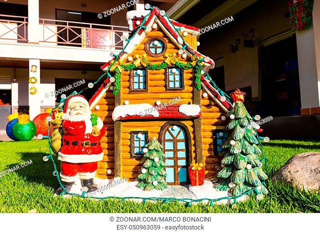 Santa Claus and little house with snow of ceramic Christmas decoration