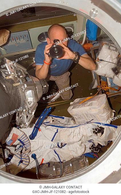 Astronaut Clay Anderson, Expedition 15 flight engineer, uses a camera in the Soyuz TMA-10 spacecraft docked to the Zarya module nadir port of the International...