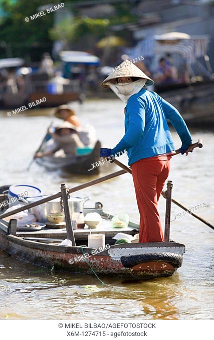 woman, rowing in a boat in a floating market  Mekong delta, Vietnam, Asia
