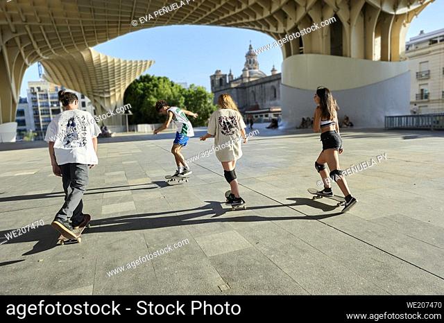 Group of young people riding on skateboard in the city