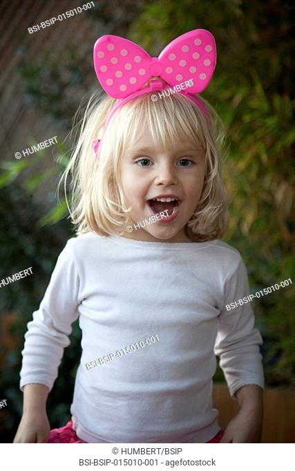 Girl wearing a headband with pink bow