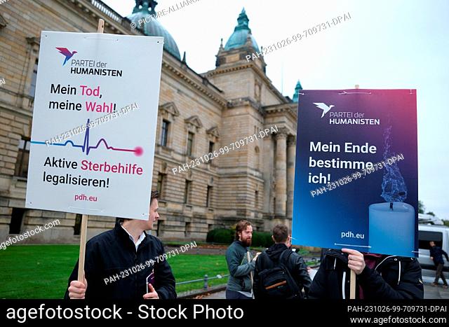 26 October 2023, Saxony, Leipzig: Activists hold signs in front of the Federal Administrative Court (BVerwG) demanding euthanasia (""My death