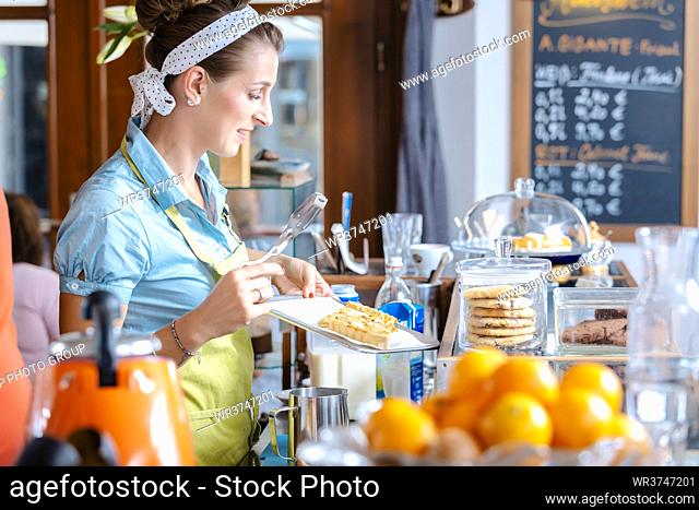 Woman holding pastries in tray at cake shop