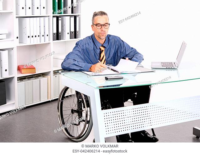 disabled business man in wheelchair working in the office