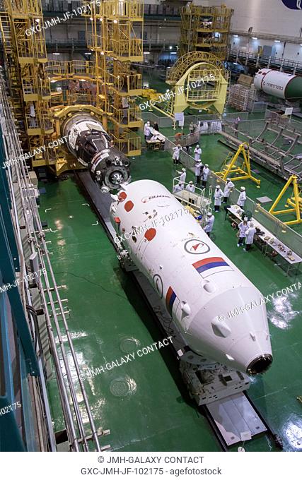At the Integration Facility at the Baikonur Cosmodrome in Kazakhstan, the Soyuz TMA-08M spacecraft (top) is aligned March 22 for its encapsulation into the...