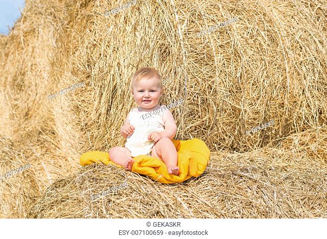 cute baby on stack of hay