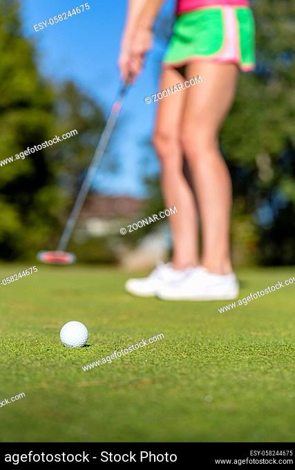 A beautiful blonde model enjoying a round of golf on a sunny day