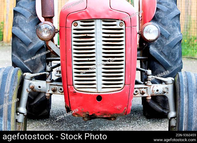 Old tractor face, red, rusty an dented