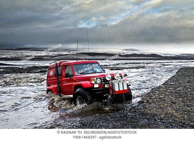 Big Red crossing the Tungnaa glacial river filled with ash from the Grimsvotn volcanic eruption, Iceland  Eruption began on May 21, 2011 spewing tons of ash
