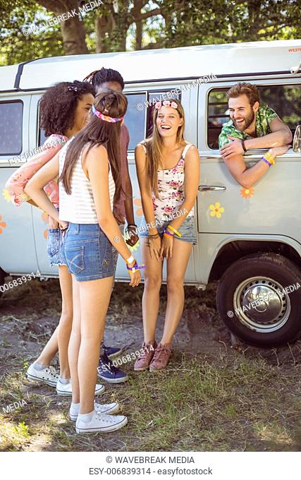 Hipsters hanging out by camper van