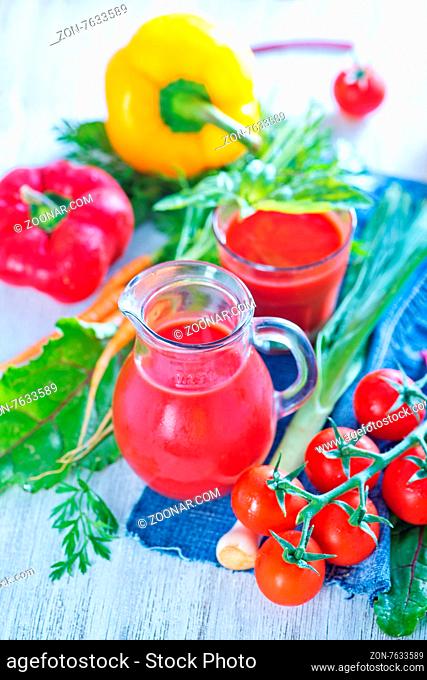 fresh vegetable juice in the glass and on a table